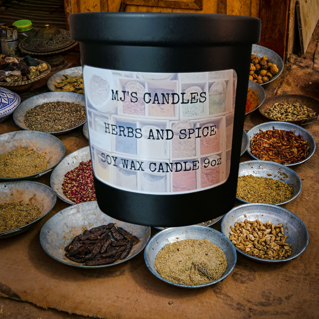 MJ'S CANDLES hand poured herbs soy candle in black jar surrounded by various herbs and spices in bowls