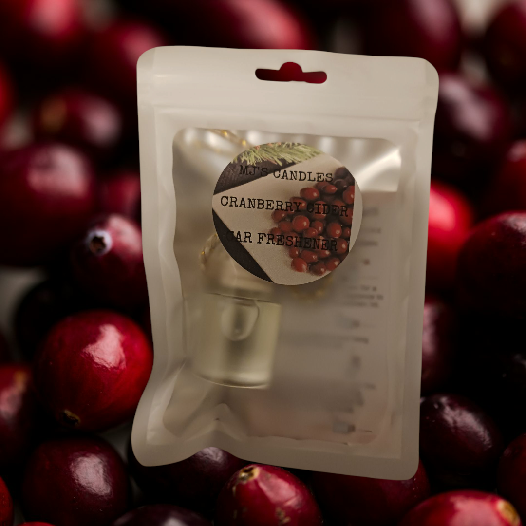 MJ'S CANDLES LLC cranberry cider car freshener in clear pouch with cranberry background