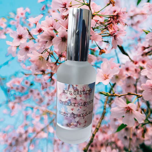 MJ'S CANDLES LLC cherry blossom body spray bottle with silver cap against pink cherry blossom flowers background