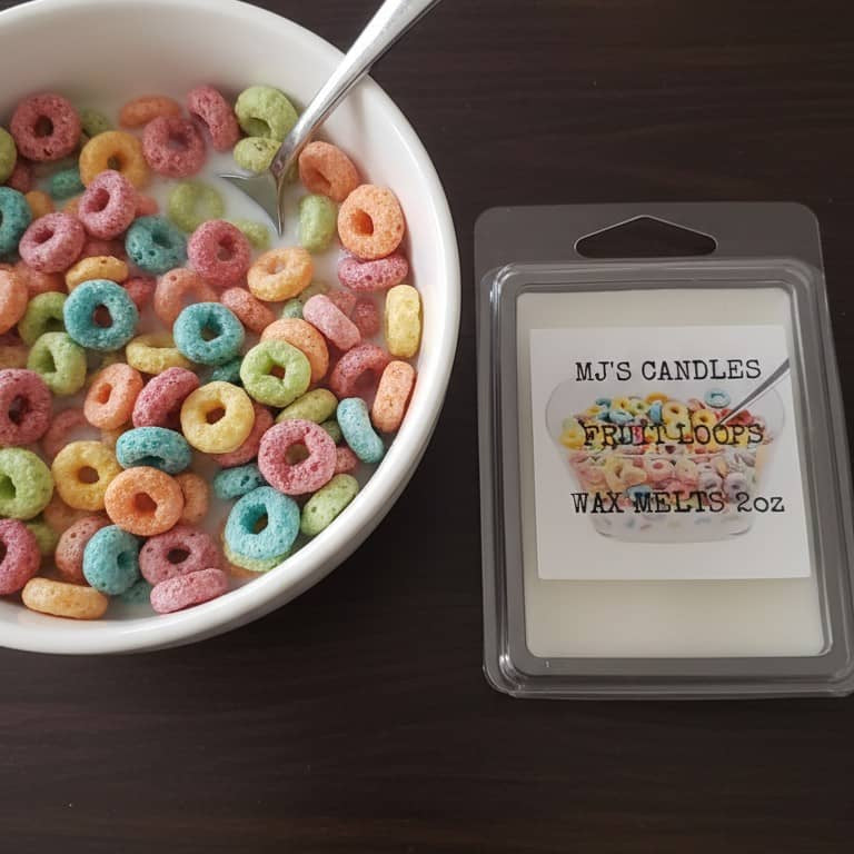 MJ'S CANDLES LLC handcrafted breakfast scent wax melt next to a bowl of colorful fruit loop cereal with a spoon