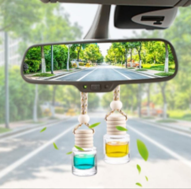 Luxury soy car air freshener hanging from rearview mirror with blue and yellow fragrance oils