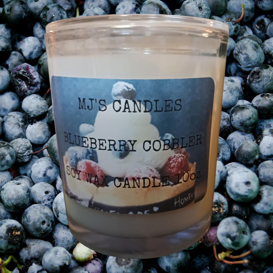 MJ'S CANDLES natural blueberry dessert candle in soy wax with blueberry cobbler label on fresh blueberries background