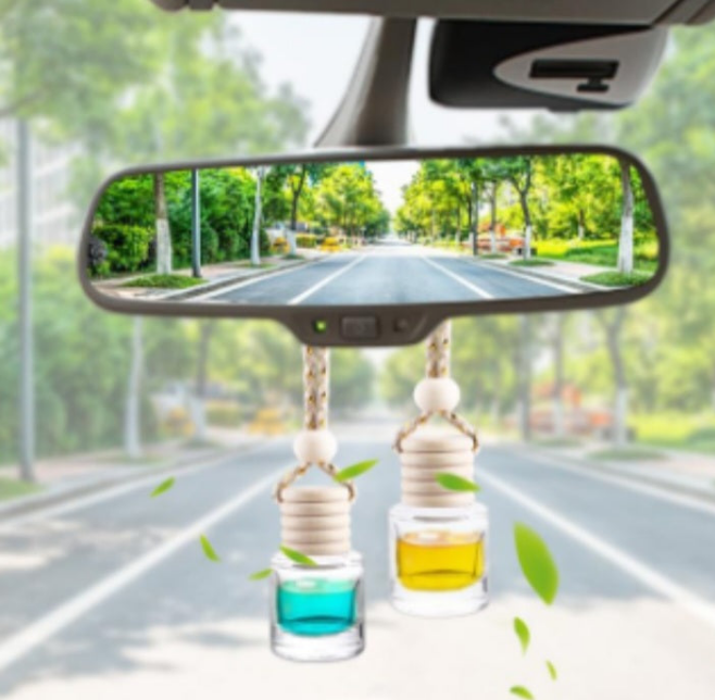 Handmade candy scented car freshener hanging from rearview mirror with blue and yellow fragrance liquid