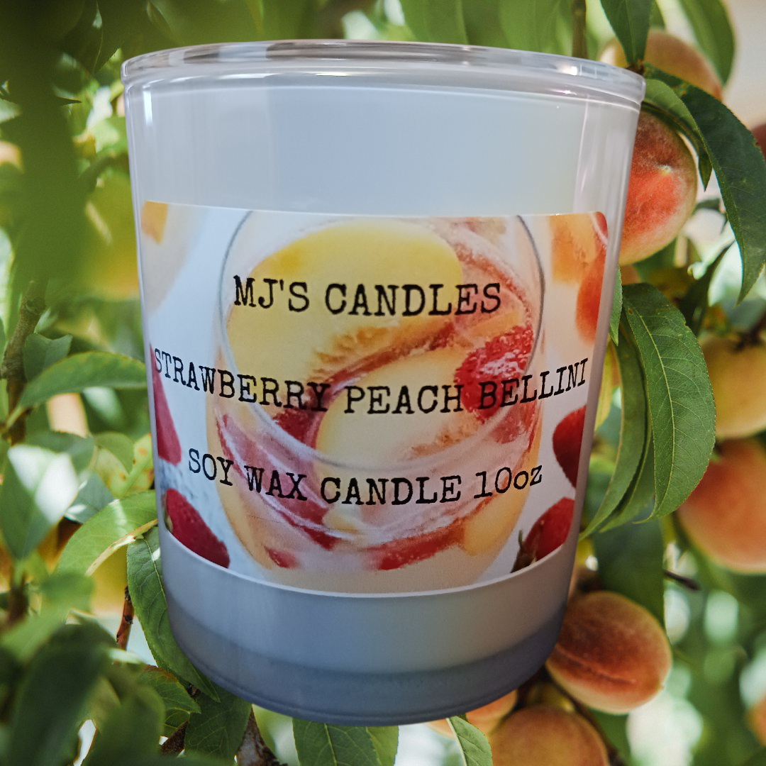 MJ'S CANDLES soy wax candle with bellini peach cocktail scent in 10oz glass container surrounded by fresh peaches