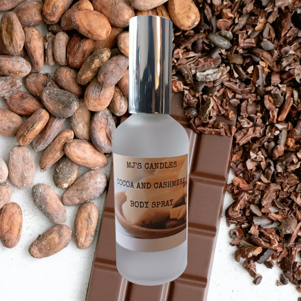 MJ'S CANDLES LLC cocoa and cashmere body spray bottle with chocolate, cocoa beans, and shells background