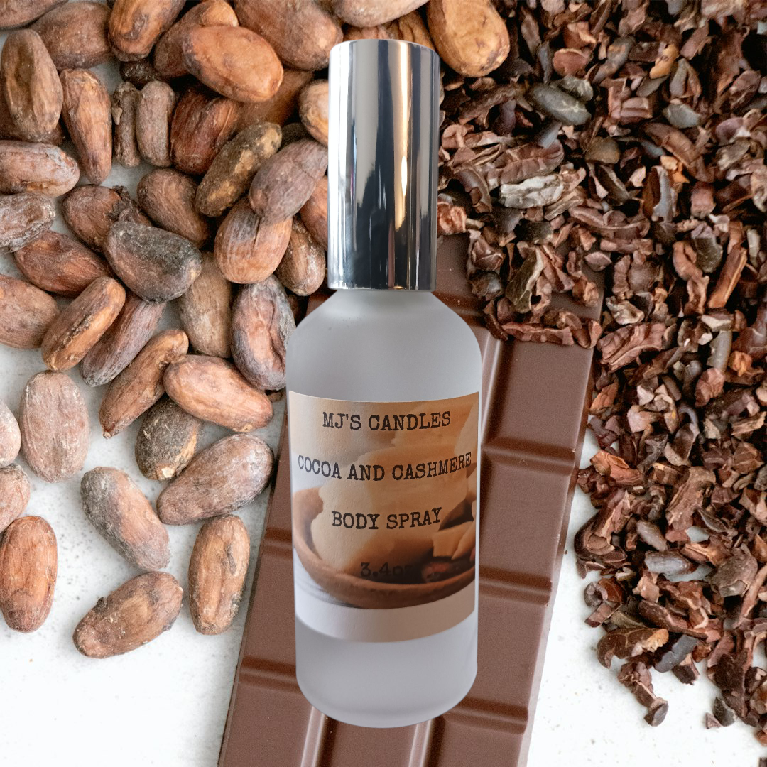 MJ'S CANDLES LLC cocoa and cashmere body spray bottle with chocolate, cocoa beans, and shells background