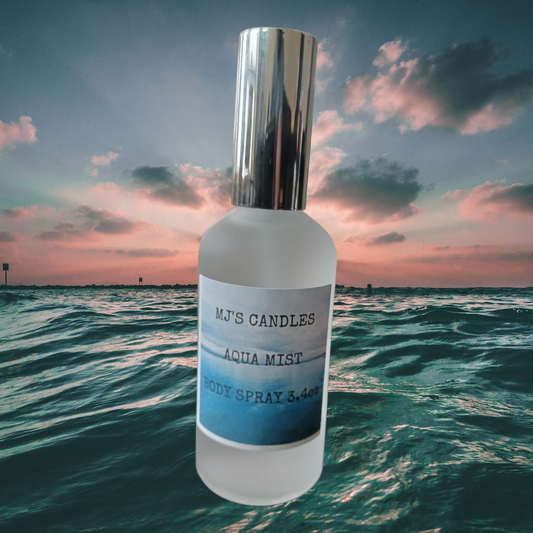 MJ'S CANDLES LLC fresh ocean scented body spray Aqua Mist bottle with silver cap over ocean background