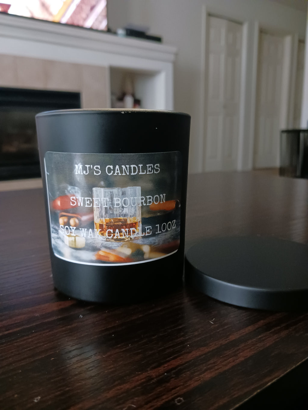 MJ'S CANDLES LLC handcrafted luxury soy candle Sweet Bourbon in black glass jar with lid on wooden table