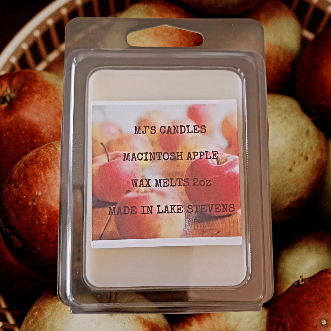 Handmade Macintosh apple wax melt from MJ'S CANDLES LLC with 2oz wax pack on apple background