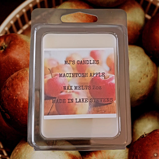 Handmade Macintosh apple wax melt from MJ'S CANDLES LLC with 2oz wax pack on apple background