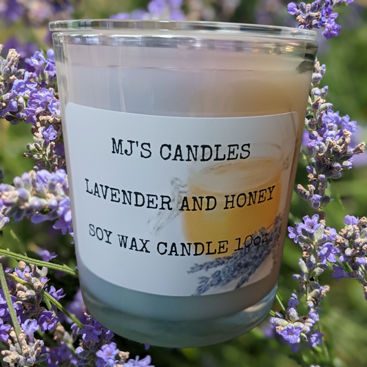 MJ'S CANDLES soy wax candle with lavender and honey home fragrance surrounded by lavender flowers