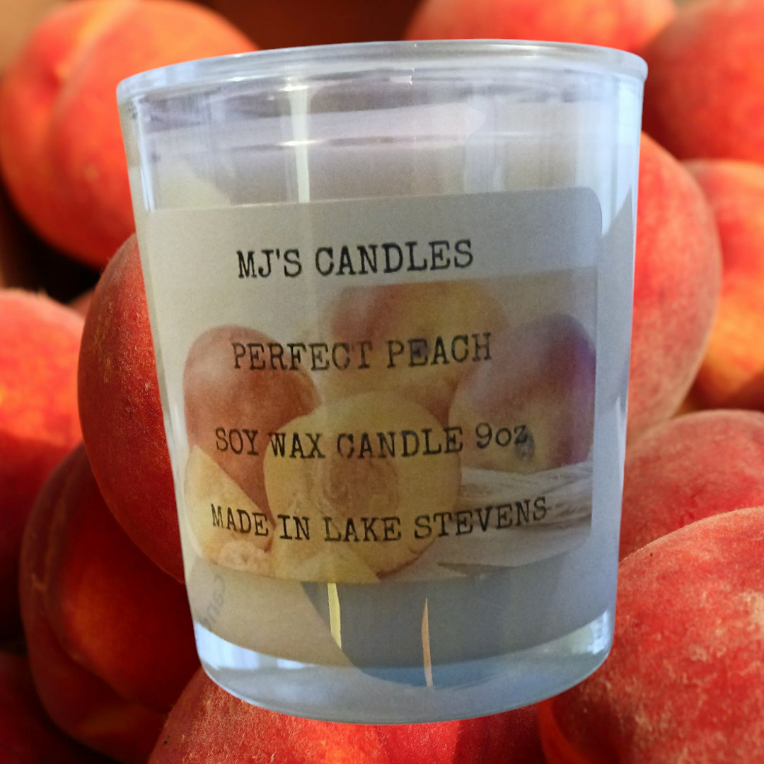 MJ'S CANDLES LLC luxury natural peach scented candle in clear glass with soy wax and peach background