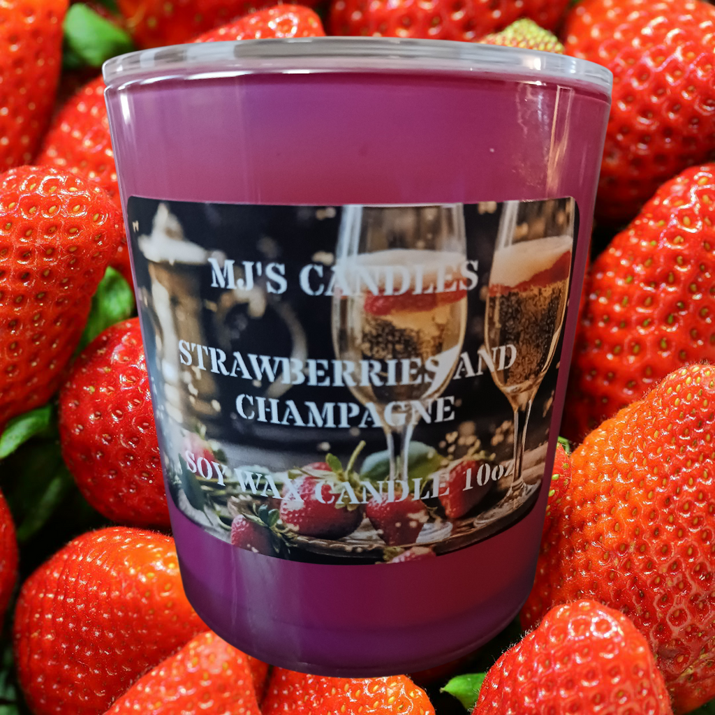 MJ'S CANDLES luxury soy candle in strawberries and champagne scent surrounded by fresh strawberries