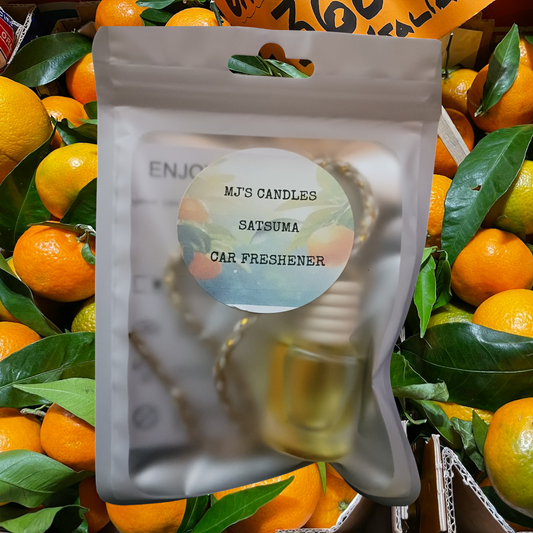 MJ'S CANDLES LLC satsuma car freshener in sealed frosted package with orange fruit background