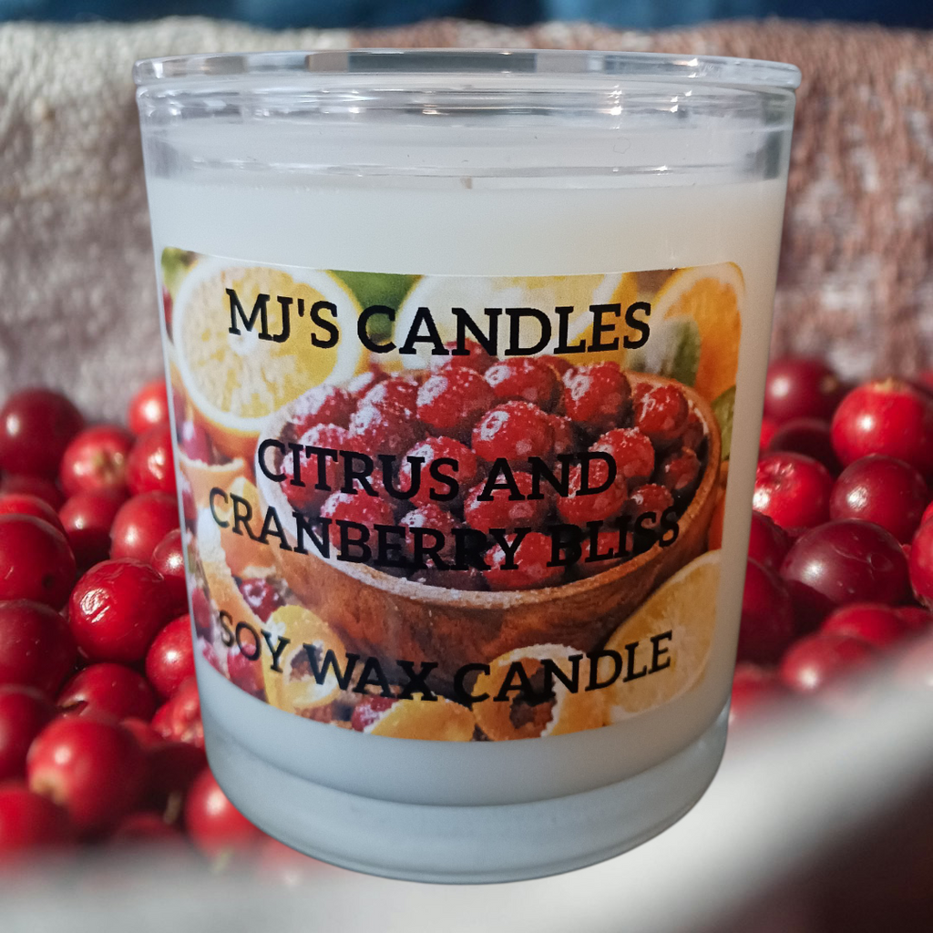 MJ'S CANDLES LLC citrus and cranberry bliss soy candle with fruit label surrounded by fresh cranberries