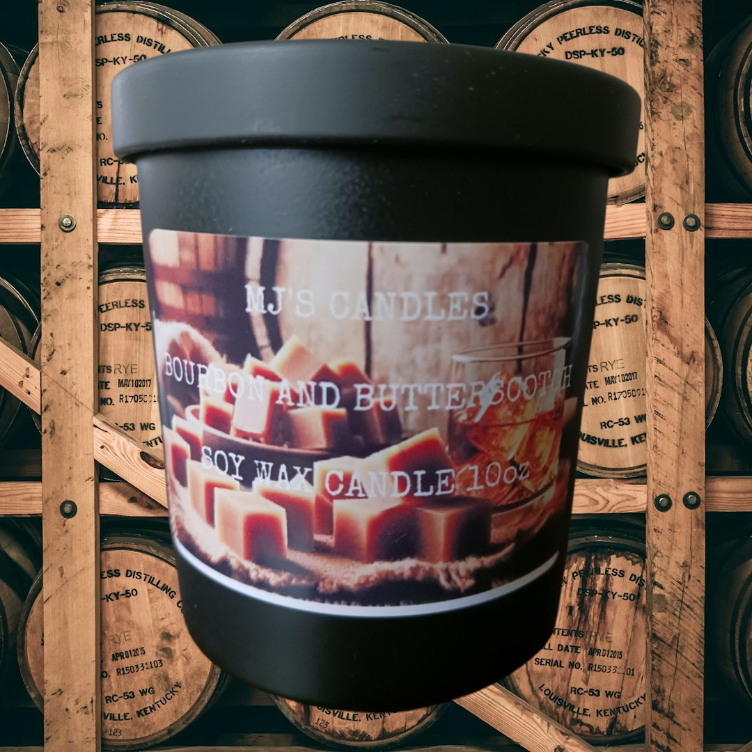 MJ'S CANDLES LLC bourbon and butterscotch soy candle wax in black container with wooden barrels background