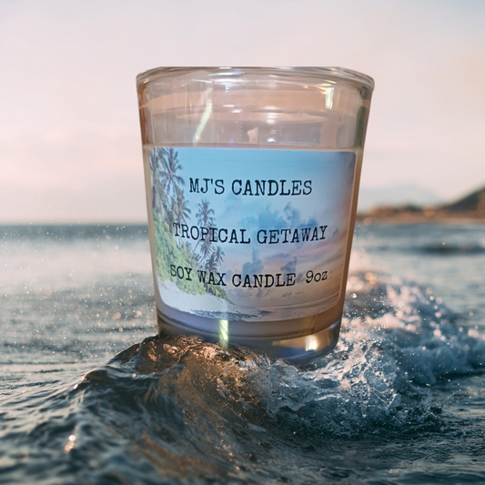MJ'S CANDLES handcrafted luxury soy candle Tropical Getaway scent in clear glass jar on ocean waves