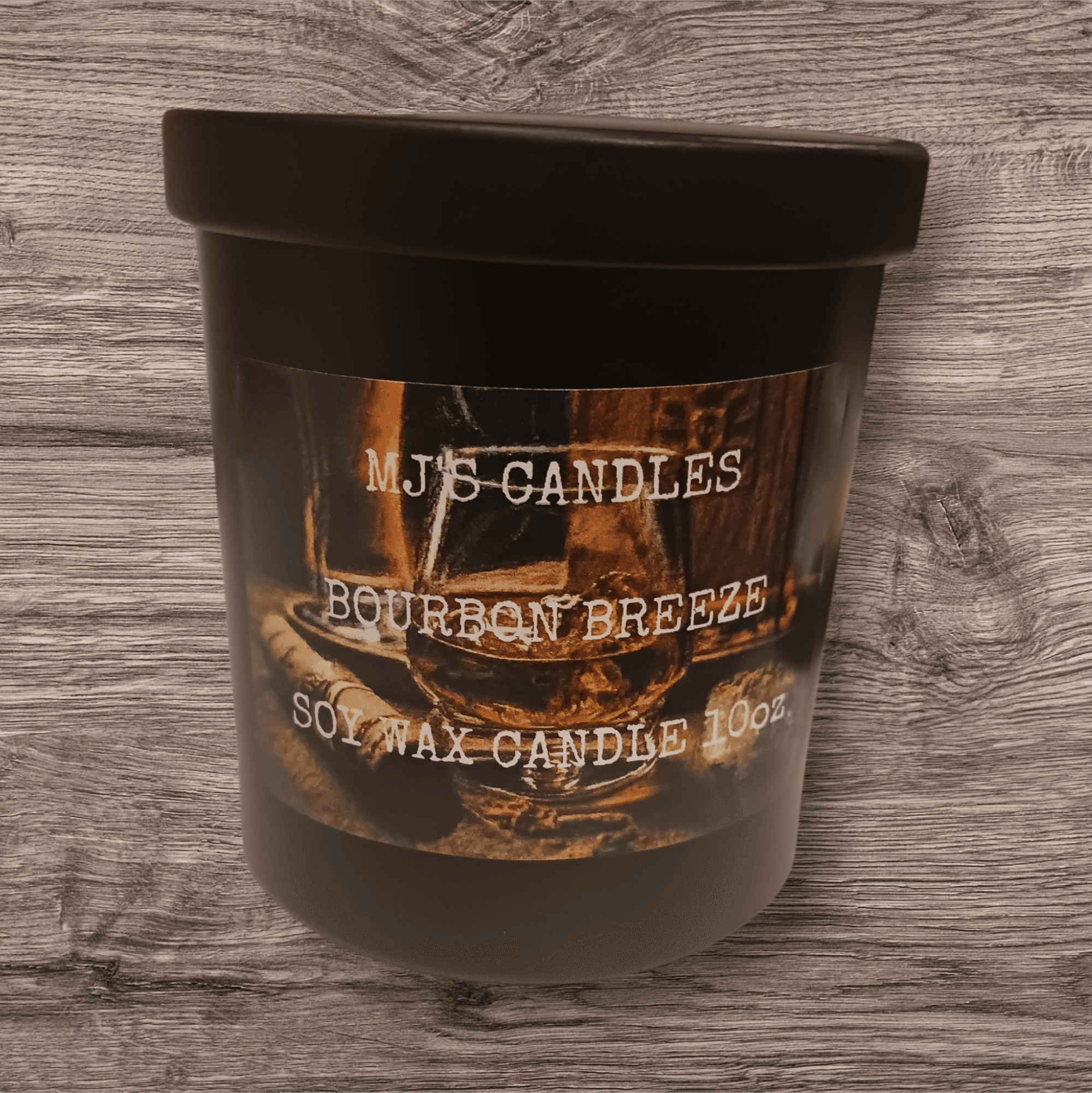 MJ'S CANDLES LLC luxury bourbon breeze candle in black container with wooden background
