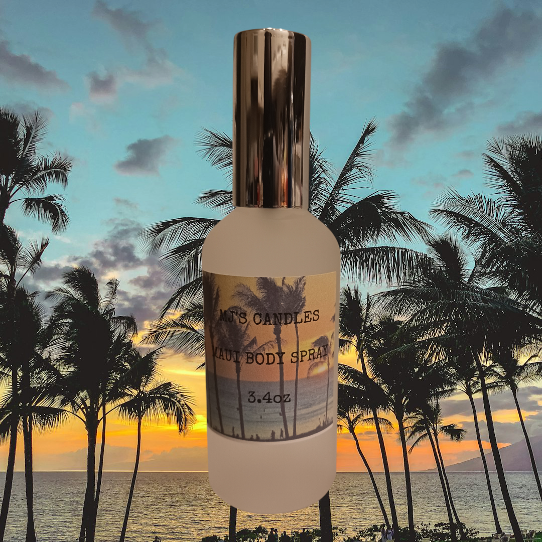 MJ'S CANDLES LLC tropical scented body mist in frosted bottle with metallic cap against palm tree sunset background